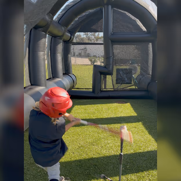 A young player swings off a tee inside the Lab.